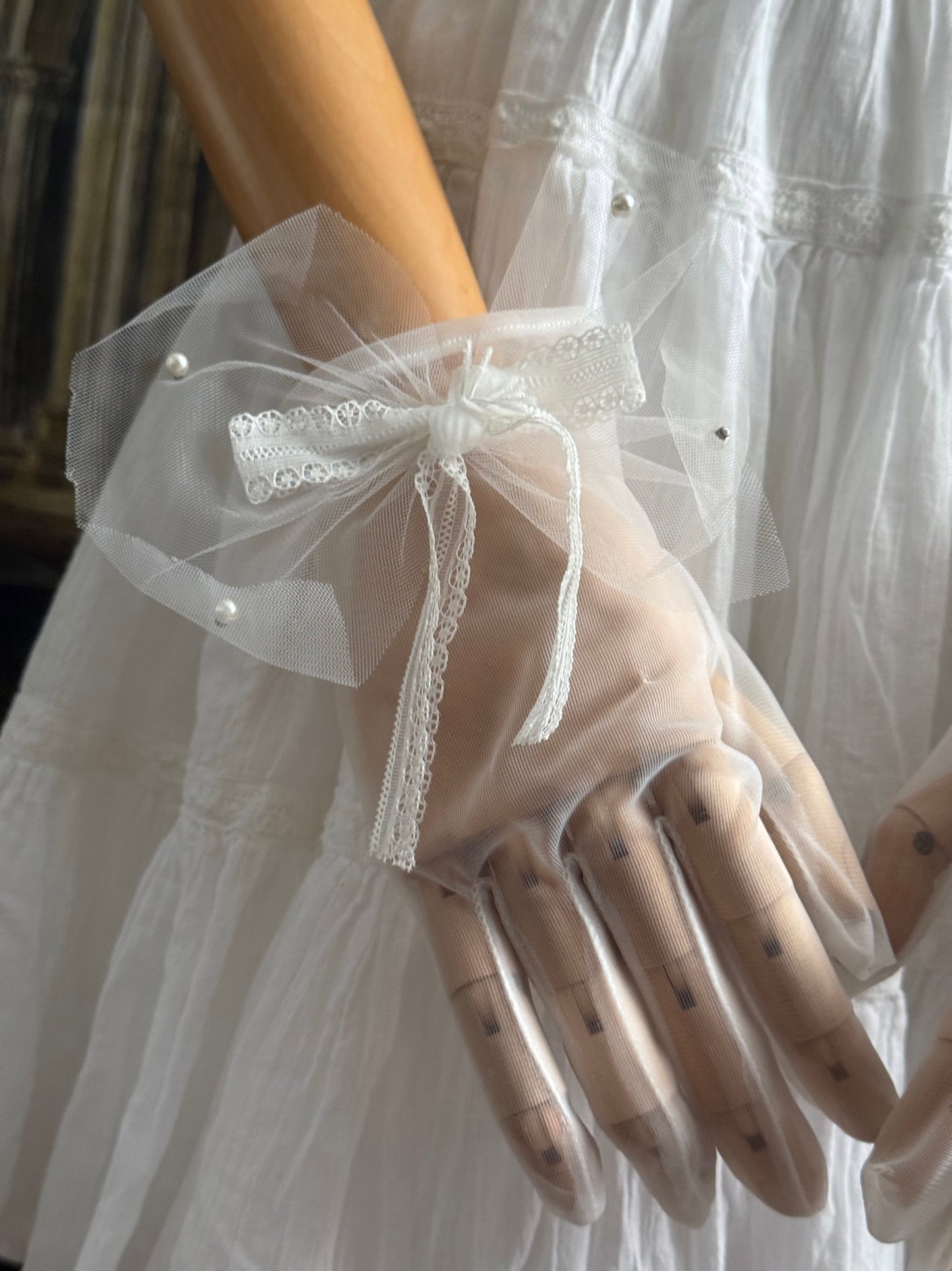 A Pair of Historically Inspired Sheer Gloves with Lace Bow Detail in White, with pearl accents. Perfect for regency, rococo, Victorian, and Edwardian eras.