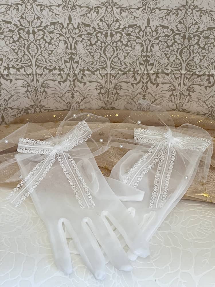 A Pair of Historically Inspired Sheer Gloves with Lace Bow Detail in White, with pearl accents. Perfect for regency, rococo, Victorian, and Edwardian eras.