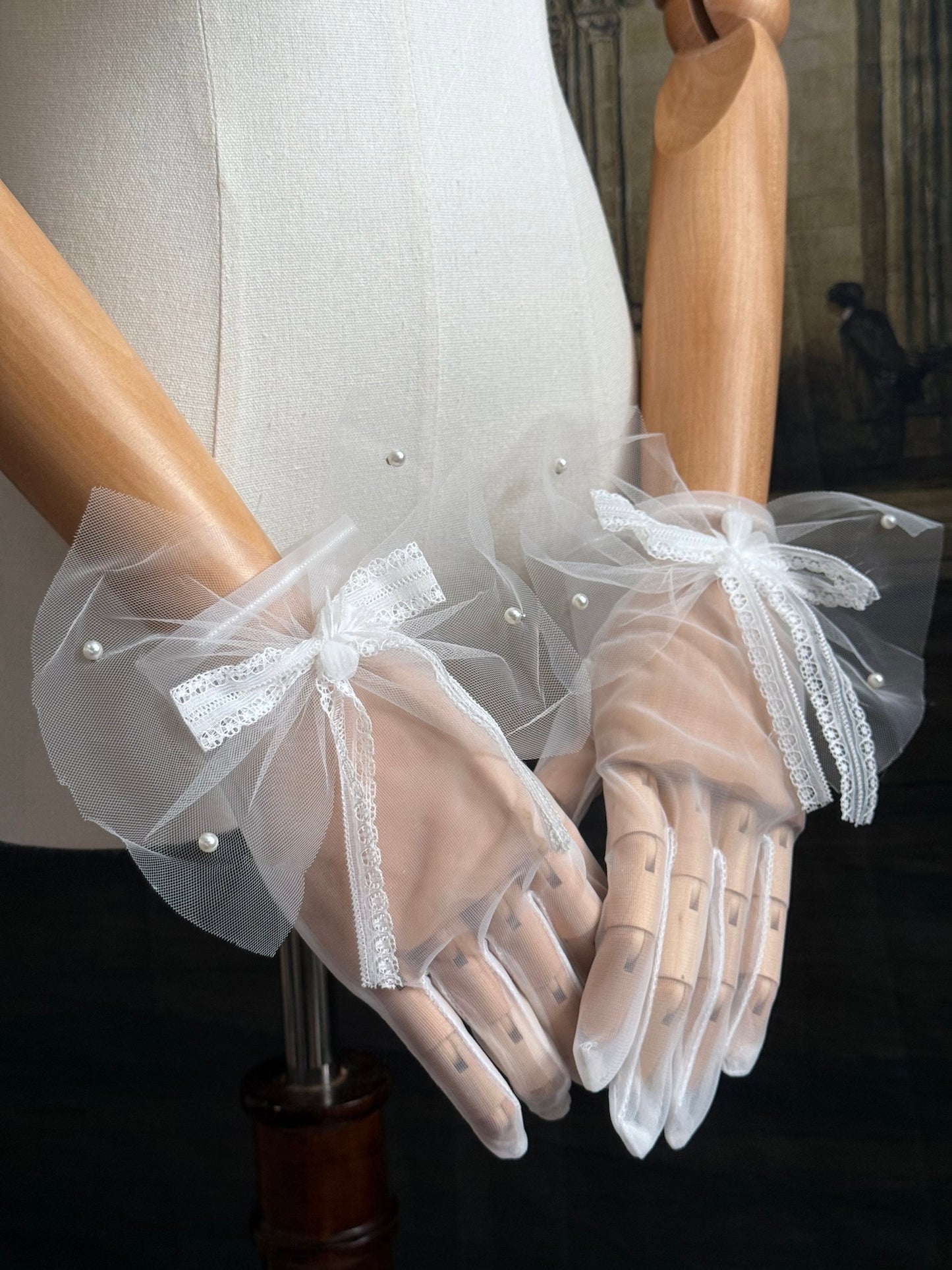 A Pair of Historically Inspired Sheer Gloves with Lace Bow Detail in White, with pearl accents. Perfect for regency, rococo, Victorian, and Edwardian eras.