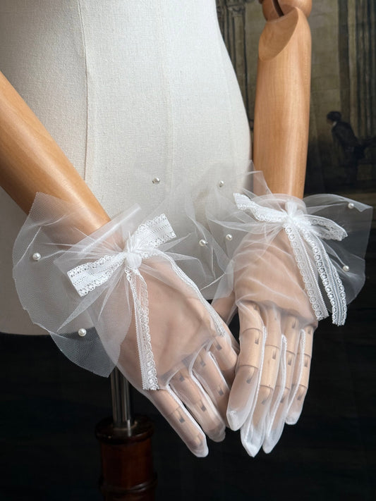 A Pair of Historically Inspired Sheer Gloves with Lace Bow Detail in White, with pearl accents. Perfect for regency, rococo, Victorian, and Edwardian eras.
