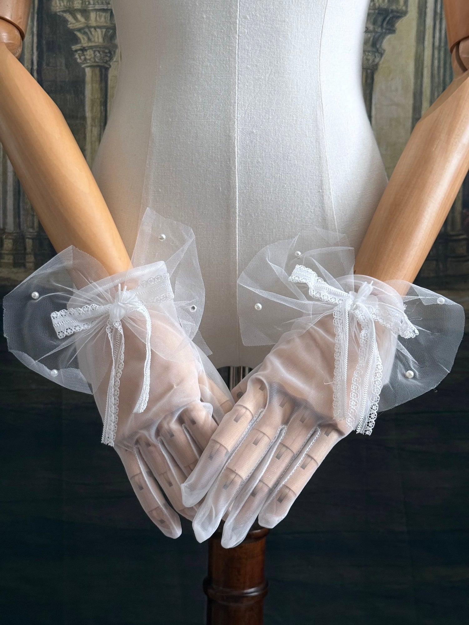 A Pair of Historically Inspired Sheer Gloves with Lace Bow Detail in White, with pearl accents. Perfect for regency, rococo, Victorian, and Edwardian eras.