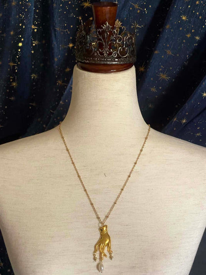 A Handmade Historically Inspired Medieval Hand Pendant Necklace with Real Baroque Pearl Dangle and Celestial Star Charms on a Metal Beaded Chain Necklace in Gold.