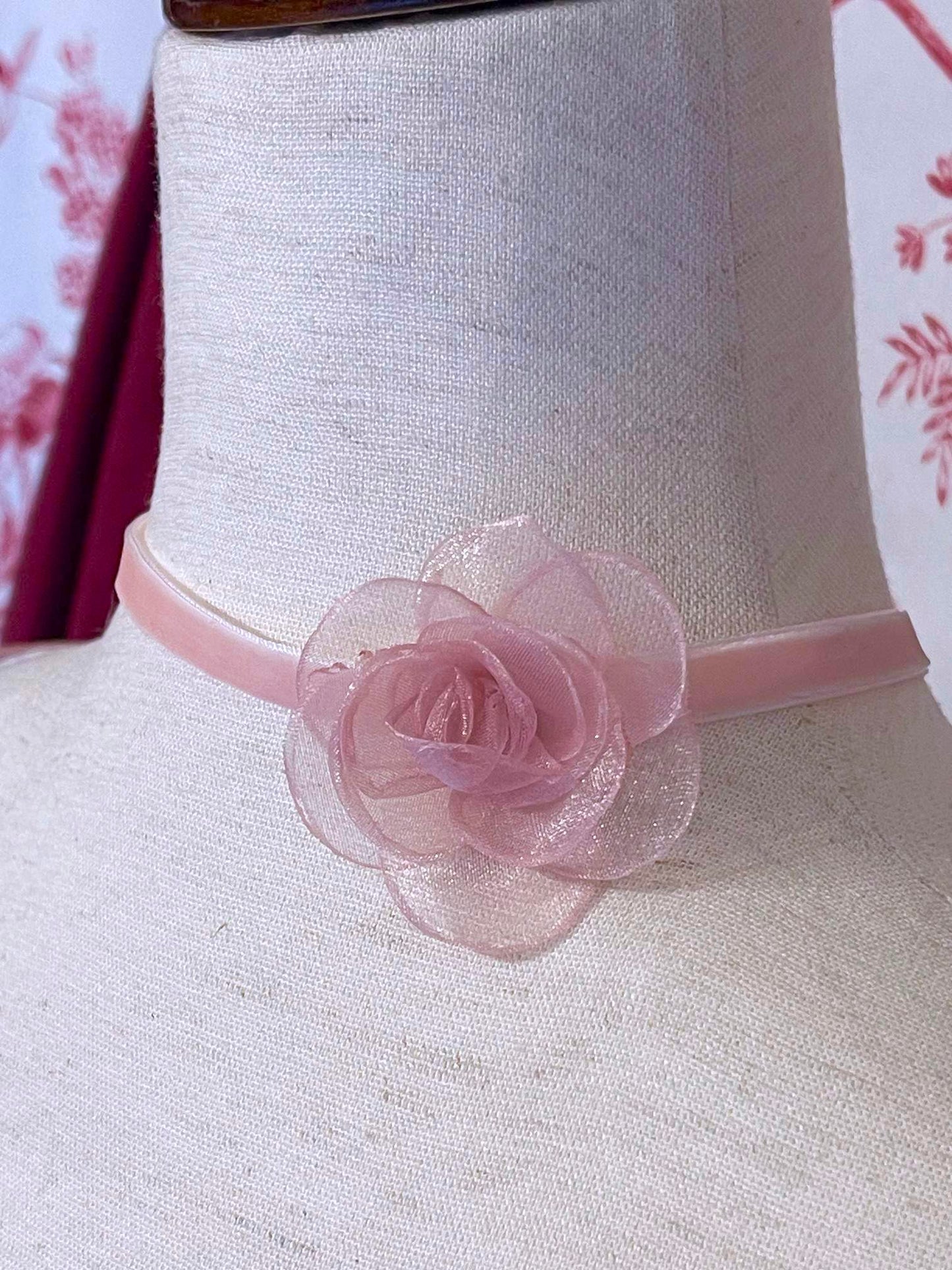 A Historically Inspired Velvet Ribbon Rosette Choker Necklace in Ballerina Pink, with claw clasp closure.