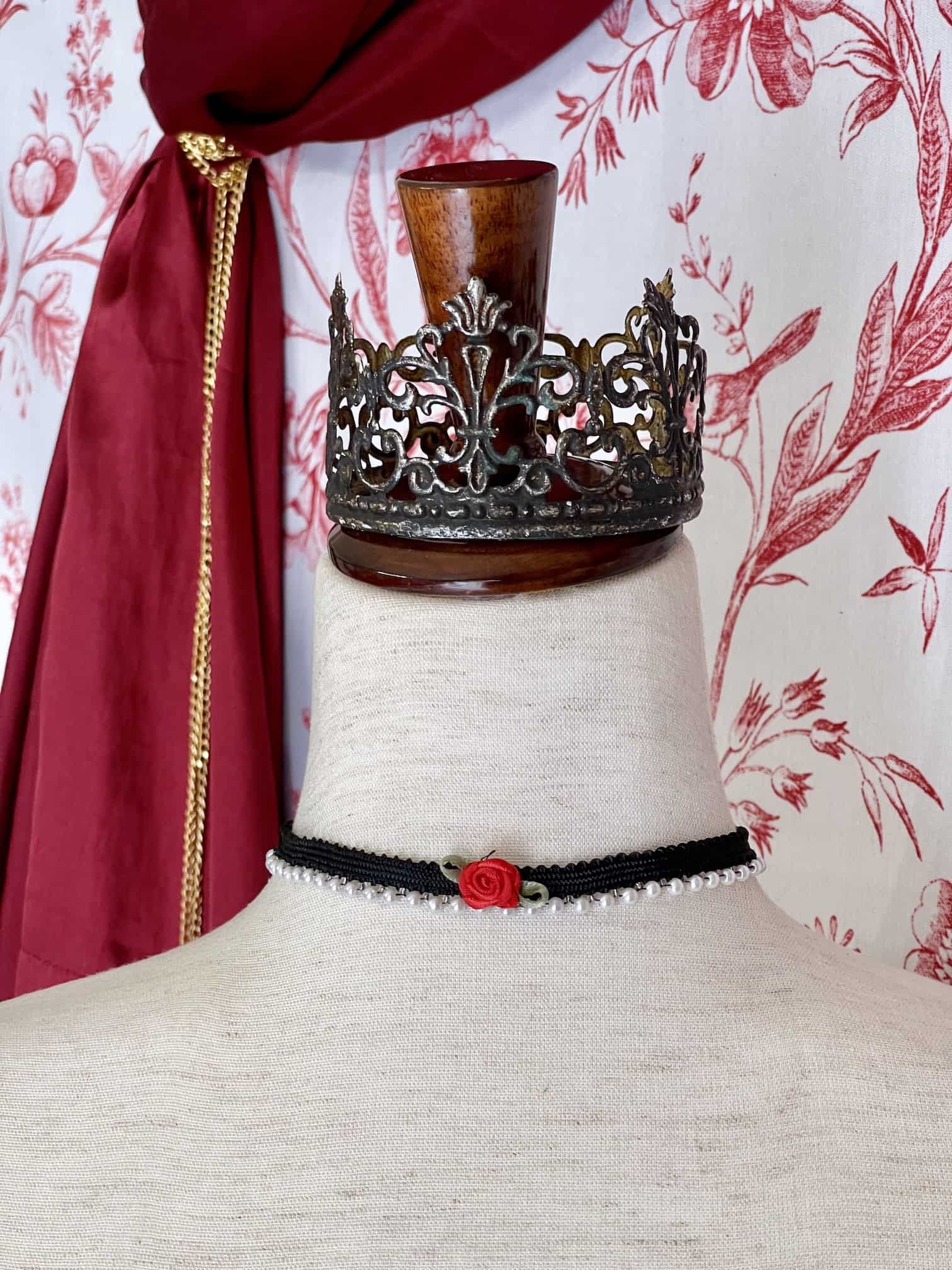A Handmade Historically Inspired Pearl Lace Choker Necklace in Gothic Black with red rosette applique.