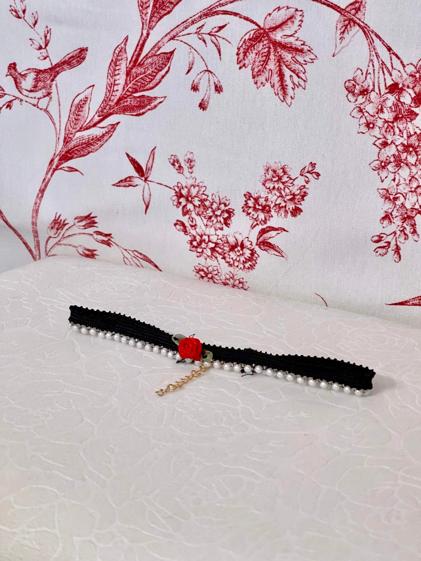 A Handmade Historically Inspired Pearl Lace Choker Necklace in Gothic Black with red rosette applique.