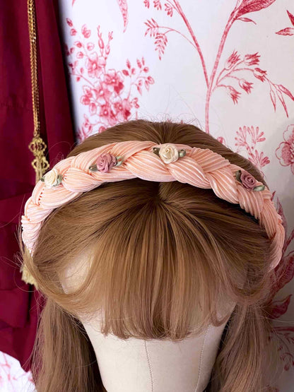 A Historically Inspired Braided Chiffon Rosette Headband in Ballerina Pink, perfect for rococo and regency era fashion.