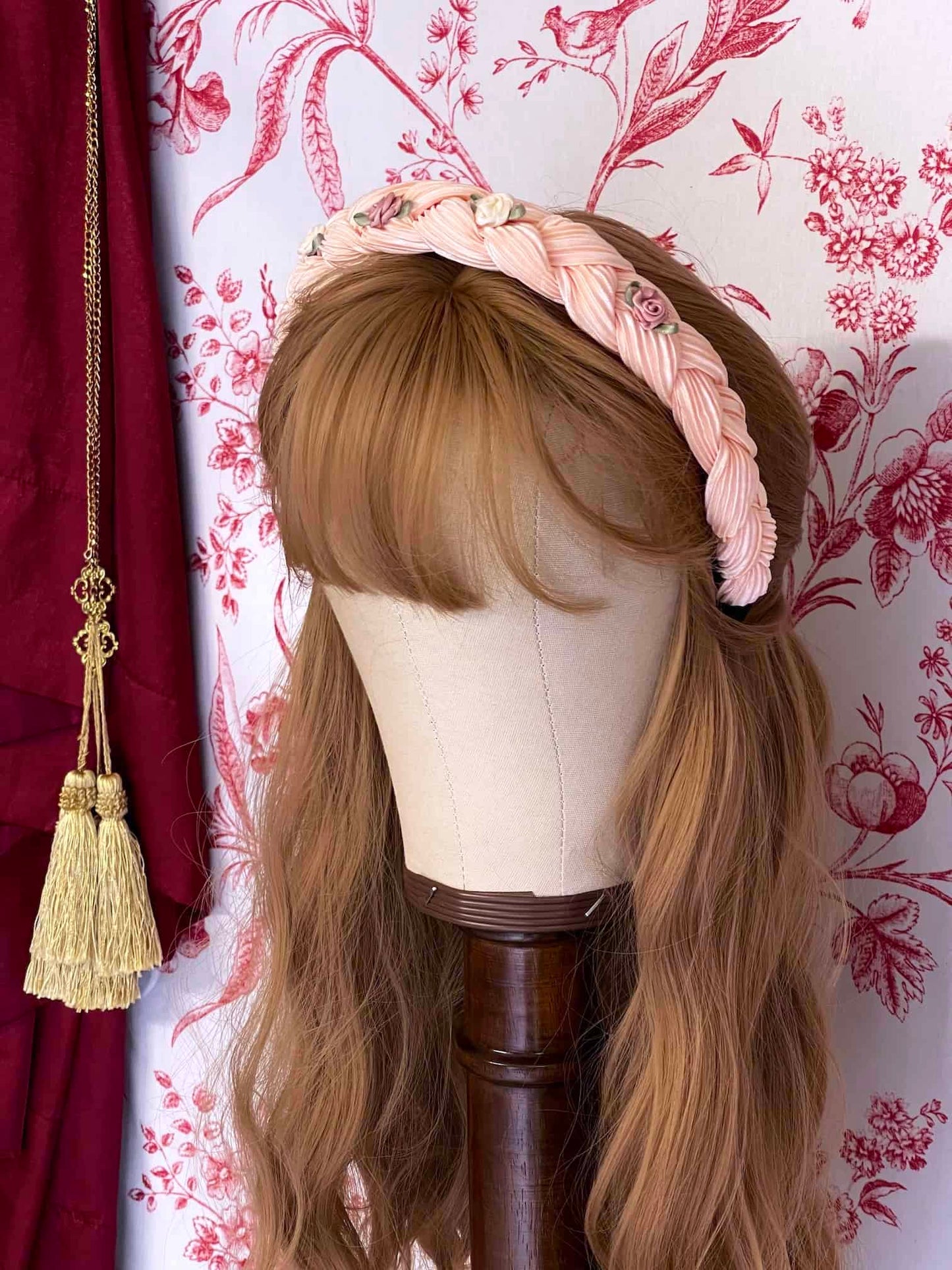 A Historically Inspired Braided Chiffon Rosette Headband in Ballerina Pink, perfect for rococo and regency era fashion.