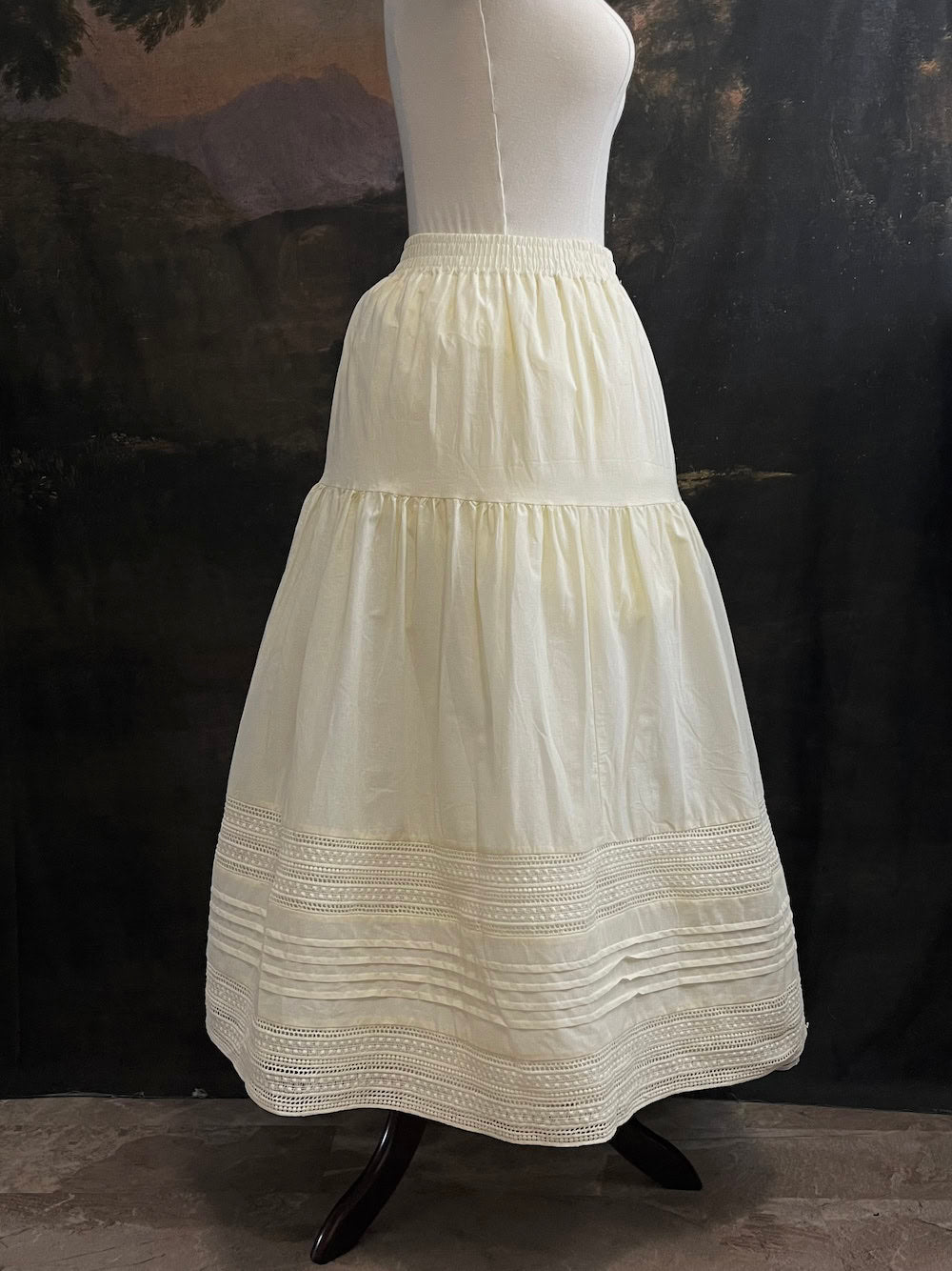 An ivory cotton victorian and baroque style historical fashion inspired petticoat maxi skirt with crochet lace inlay and pleated details 