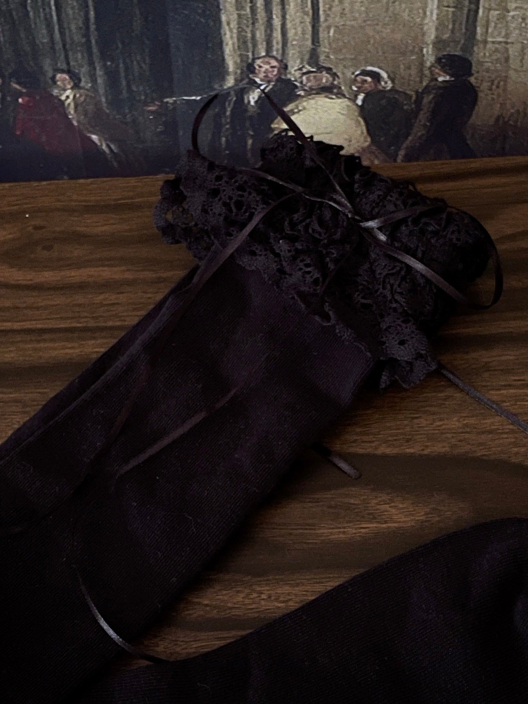 Historically Inspired Cotton Knee-High Socks with Lace Trim in  gothic Black in front of a historical painting backdrop.