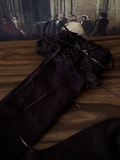 Historically Inspired Cotton Knee-High Socks with Lace Trim in  gothic Black in front of a historical painting backdrop.