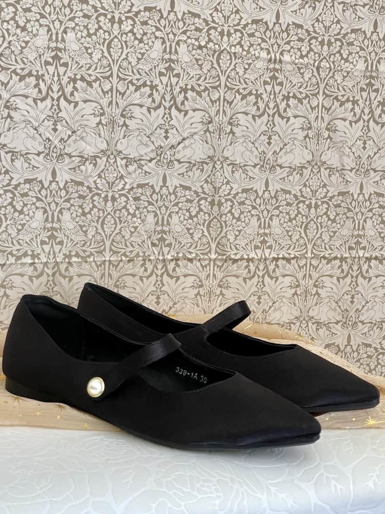 A pair of historically inspired Medieval & Renaissance Satin Pointed Toe Poulaine Flat shoes in Gothic Black with pearl accent.