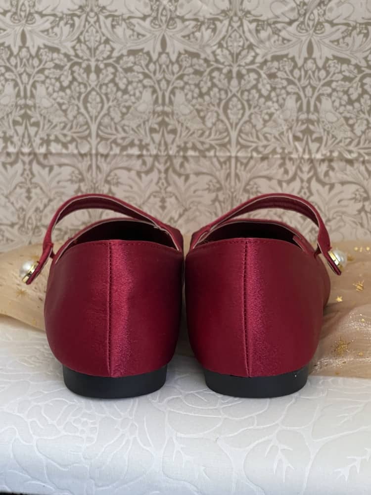 A pair of historically inspired Medieval & Renaissance Satin Pointed Toe Poulaine Flat shoes in Burgundy Red with pearl accent.