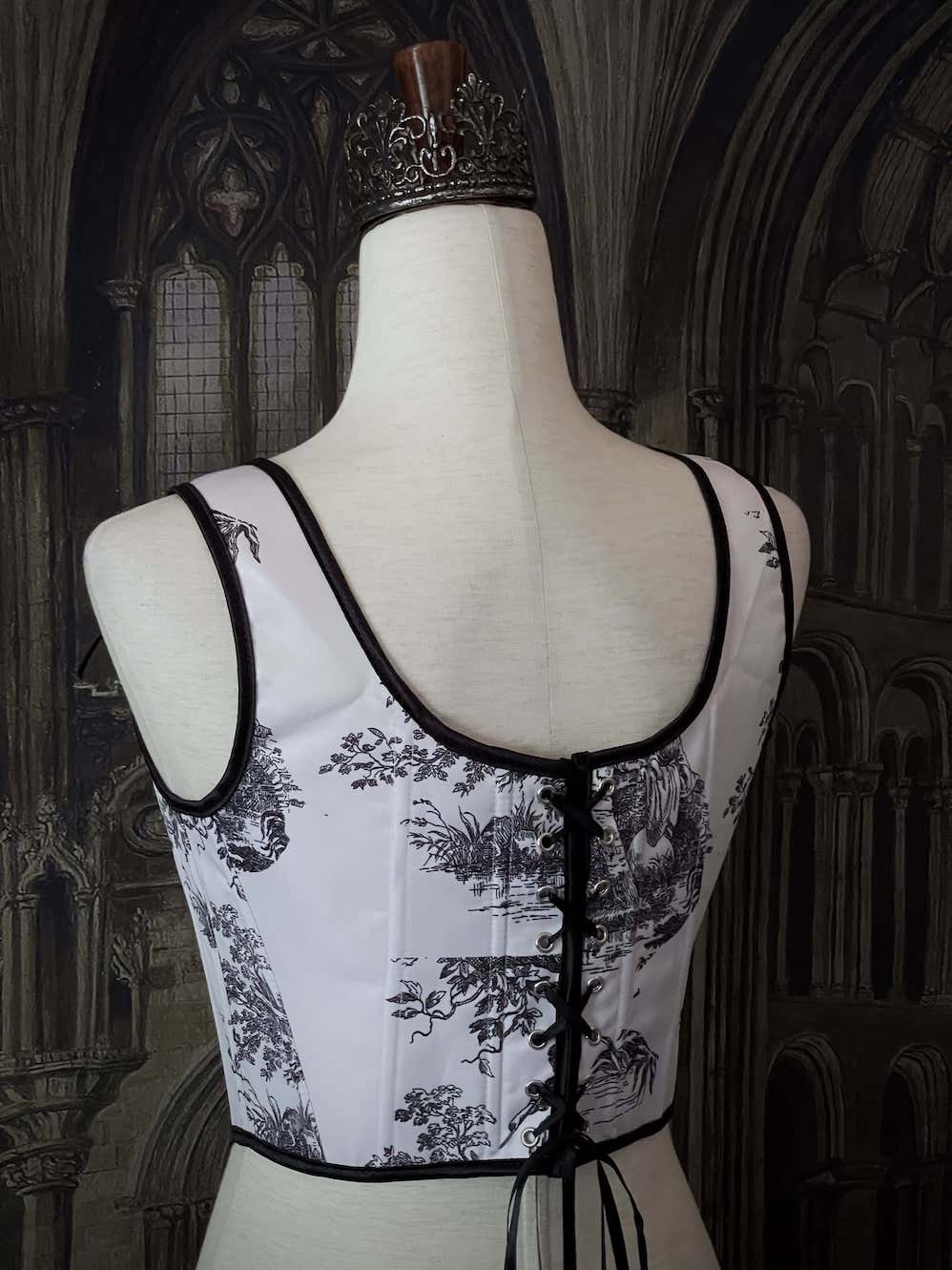 A Pair of Baroque & Rococo Era Gothic Black & White Toile Corset Stays with Satin Bowtied Ribbons.