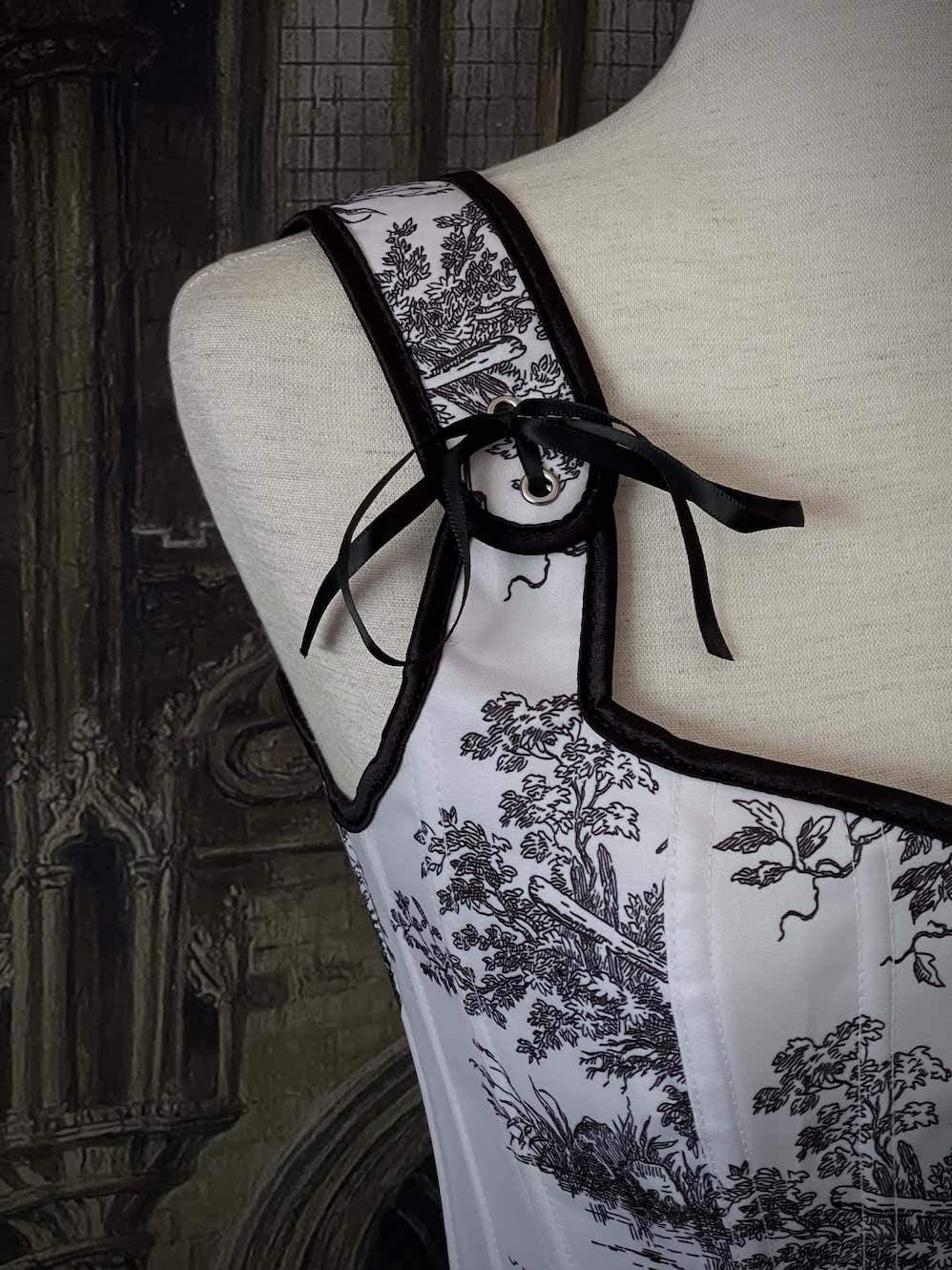 A Pair of Baroque & Rococo Era Gothic Black & White Toile Corset Stays with Satin Bowtied Ribbons.