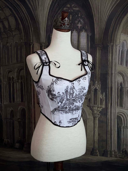 A Pair of Baroque & Rococo Era Gothic Black & White Toile Corset Stays with Satin Bowtied Ribbons.