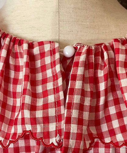A Historically Inspired vintage style victorian countryside cottage gingham tunic dress in red and white, with ruffle collar and scalloped hem bishop sleeves.