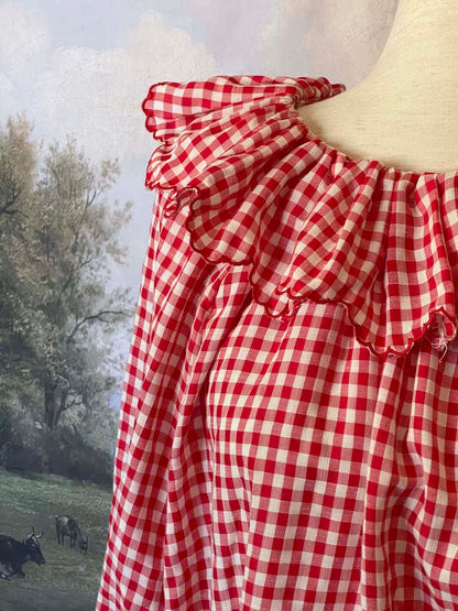 A Historically Inspired vintage style victorian countryside cottage gingham tunic dress in red and white, with ruffle collar and scalloped hem bishop sleeves.