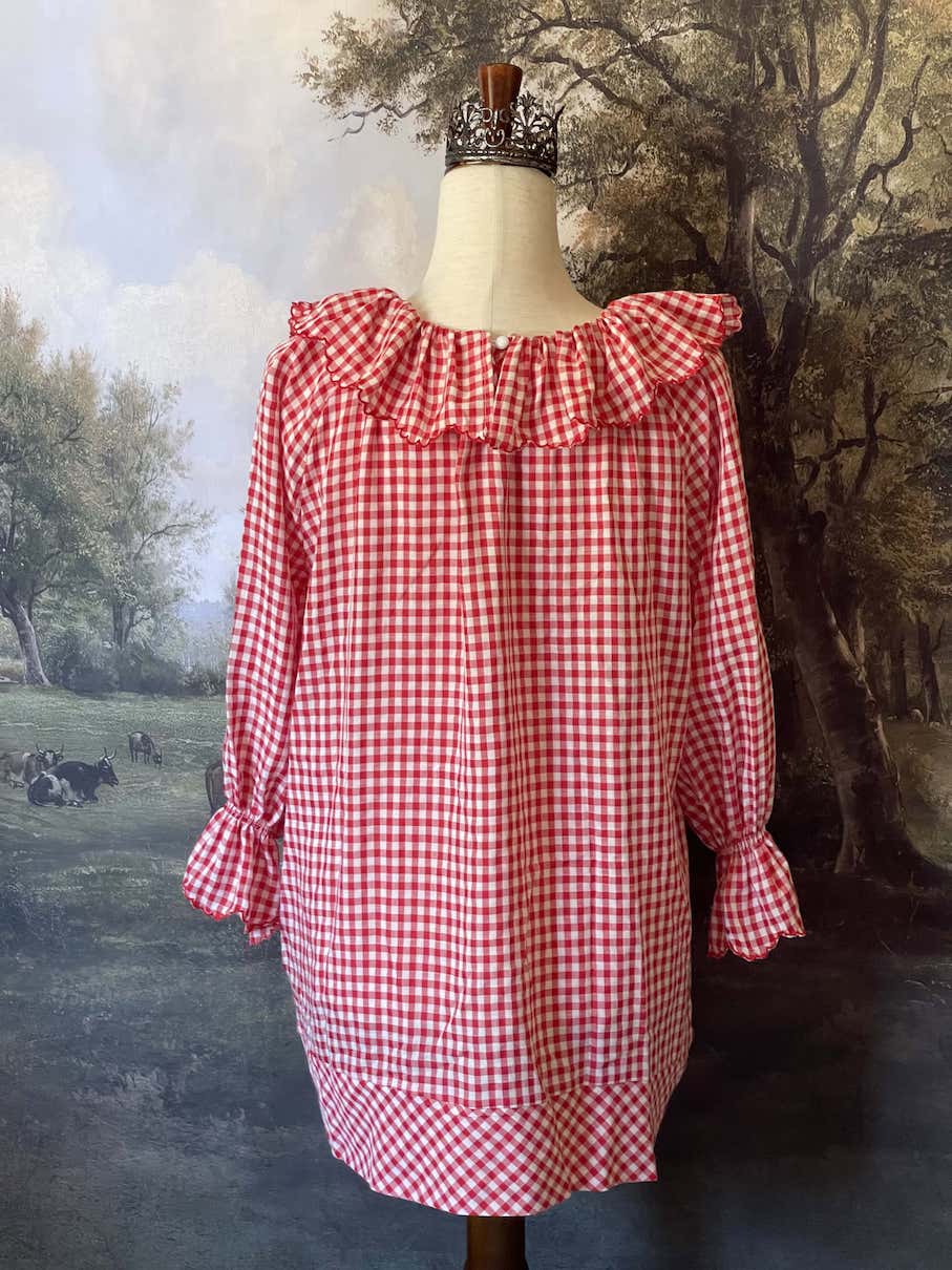 A Historically Inspired vintage style victorian countryside cottage gingham tunic dress in red and white, with ruffle collar and scalloped hem bishop sleeves.