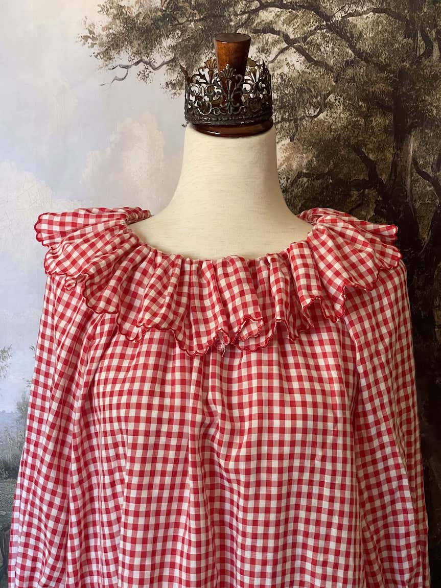 A Historically Inspired vintage style victorian countryside cottage gingham tunic dress in red and white, with ruffle collar and scalloped hem bishop sleeves.