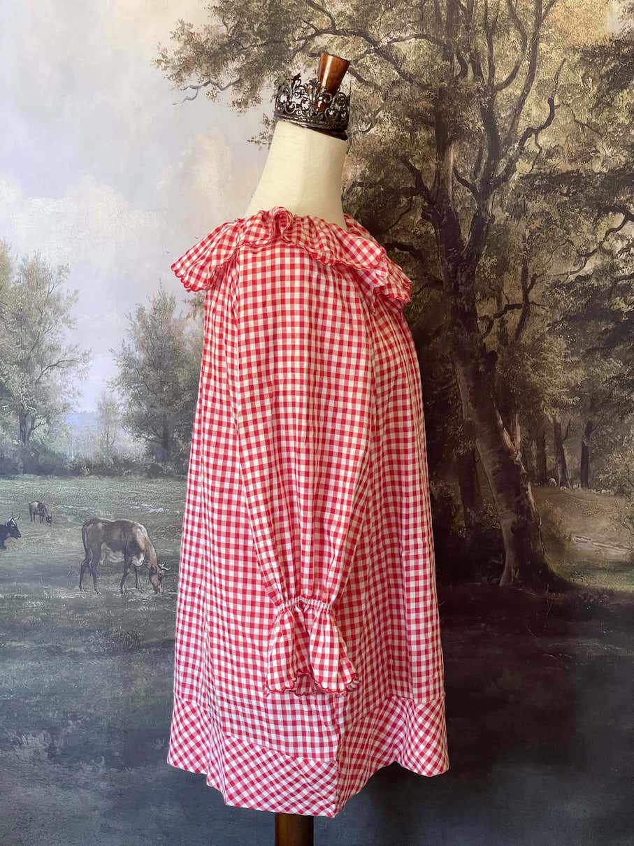 A Historically Inspired vintage style victorian countryside cottage gingham tunic dress in red and white, with ruffle collar and scalloped hem bishop sleeves.