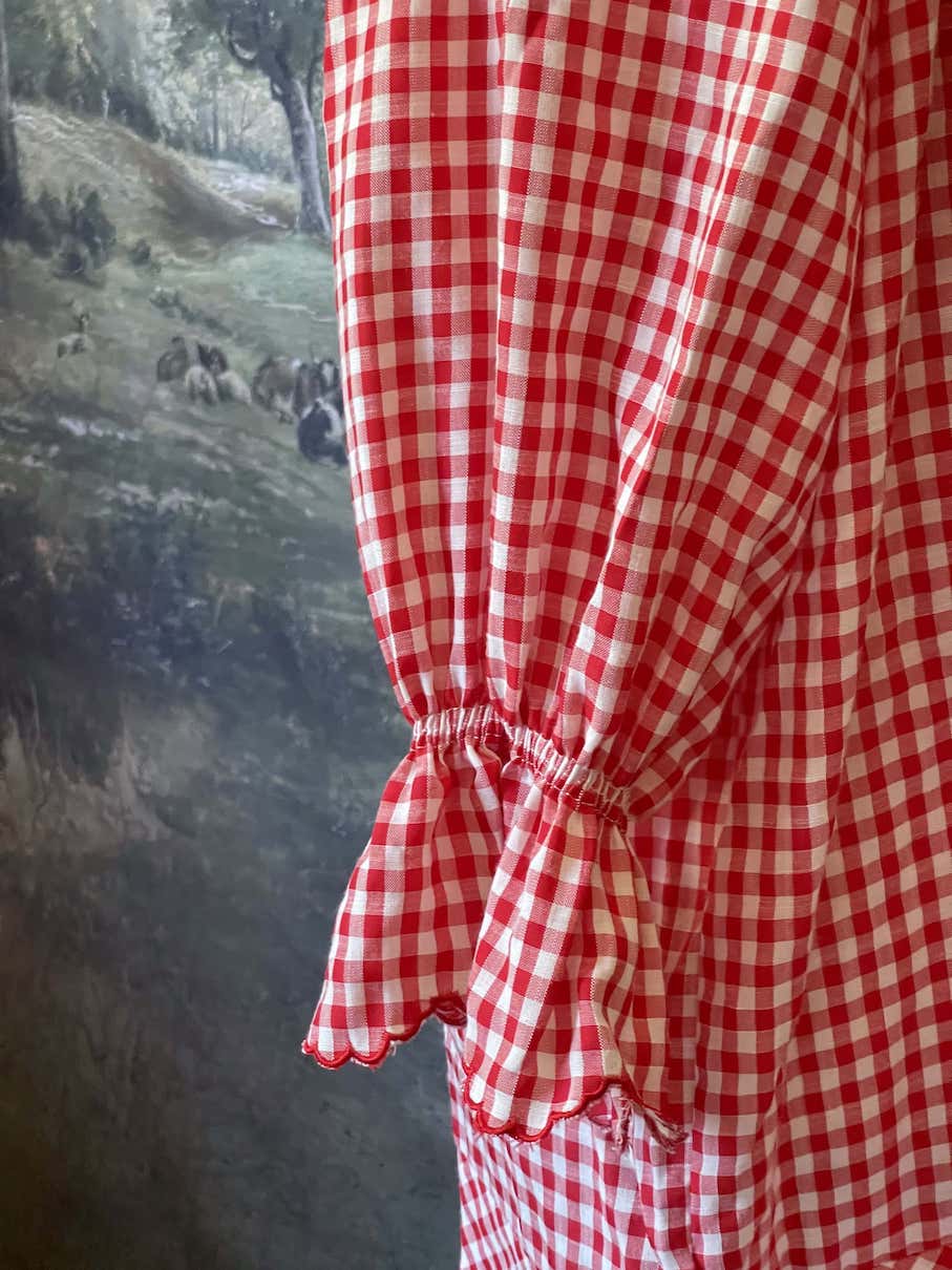 A Historically Inspired vintage style victorian countryside cottage gingham tunic dress in red and white, with ruffle collar and scalloped hem bishop sleeves.