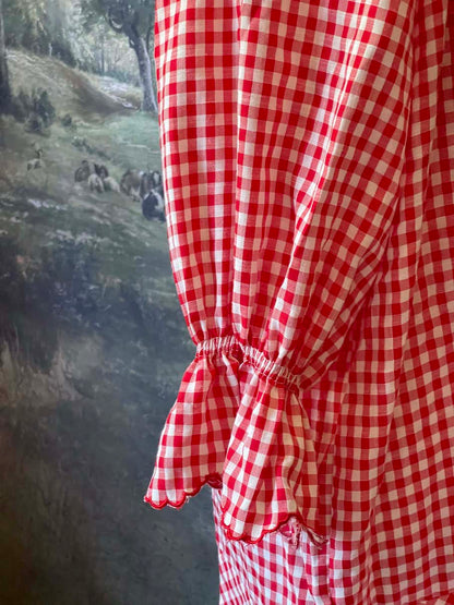A Historically Inspired vintage style victorian countryside cottage gingham tunic dress in red and white, with ruffle collar and scalloped hem bishop sleeves.