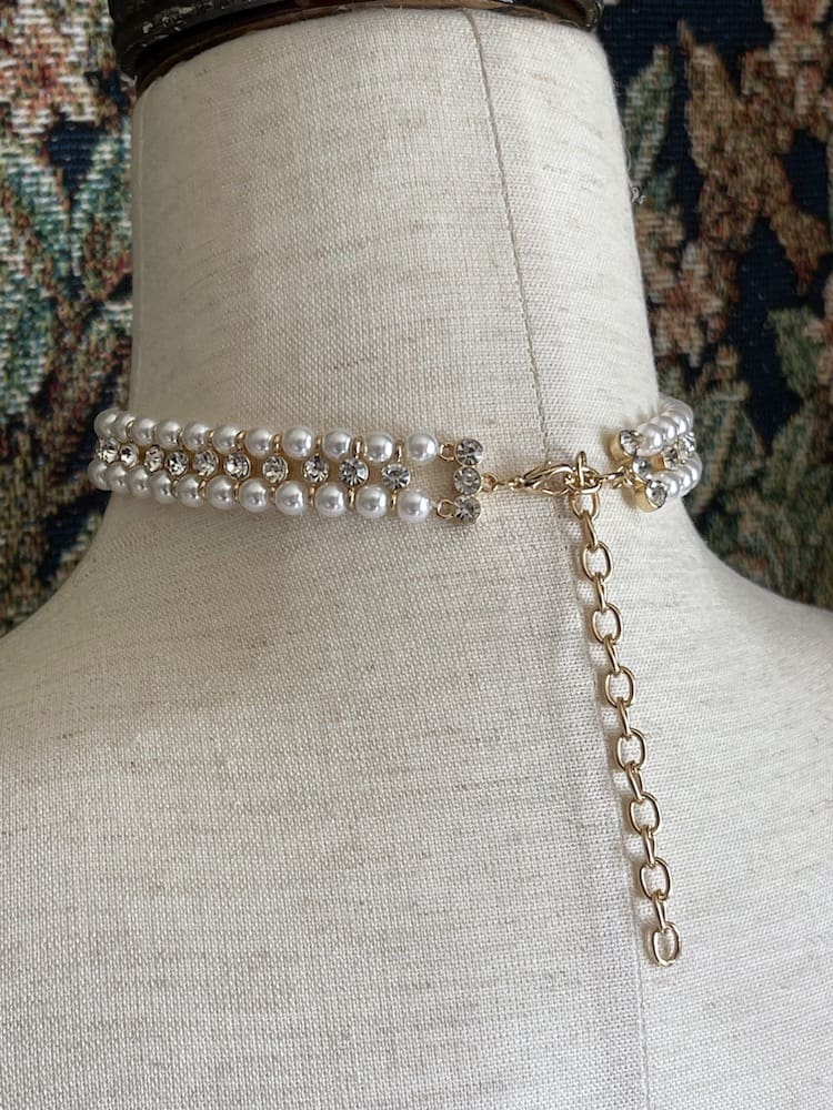 A Historically inspired renaissance tudor baroque rococo regency victorian edwardian pearl beaded crystal accent choker necklace in black is pictured on a mannequin.