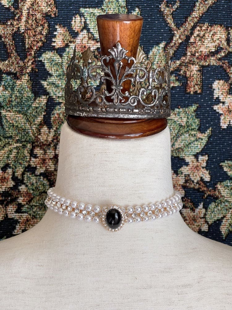 A Historically inspired renaissance tudor baroque rococo regency victorian edwardian pearl beaded crystal accent choker necklace in black is pictured on a mannequin.