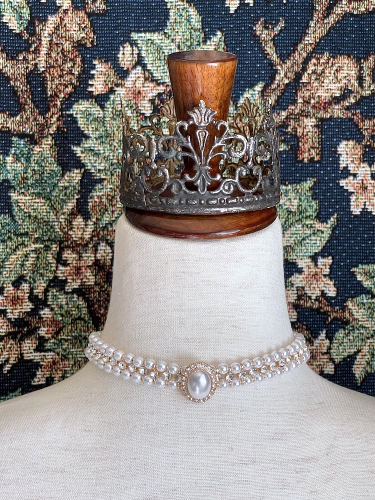 A Historically inspired renaissance baroque tudor rococo regency victorian edwardian style pearl and crystal choker necklace is pictured on a mannequin.