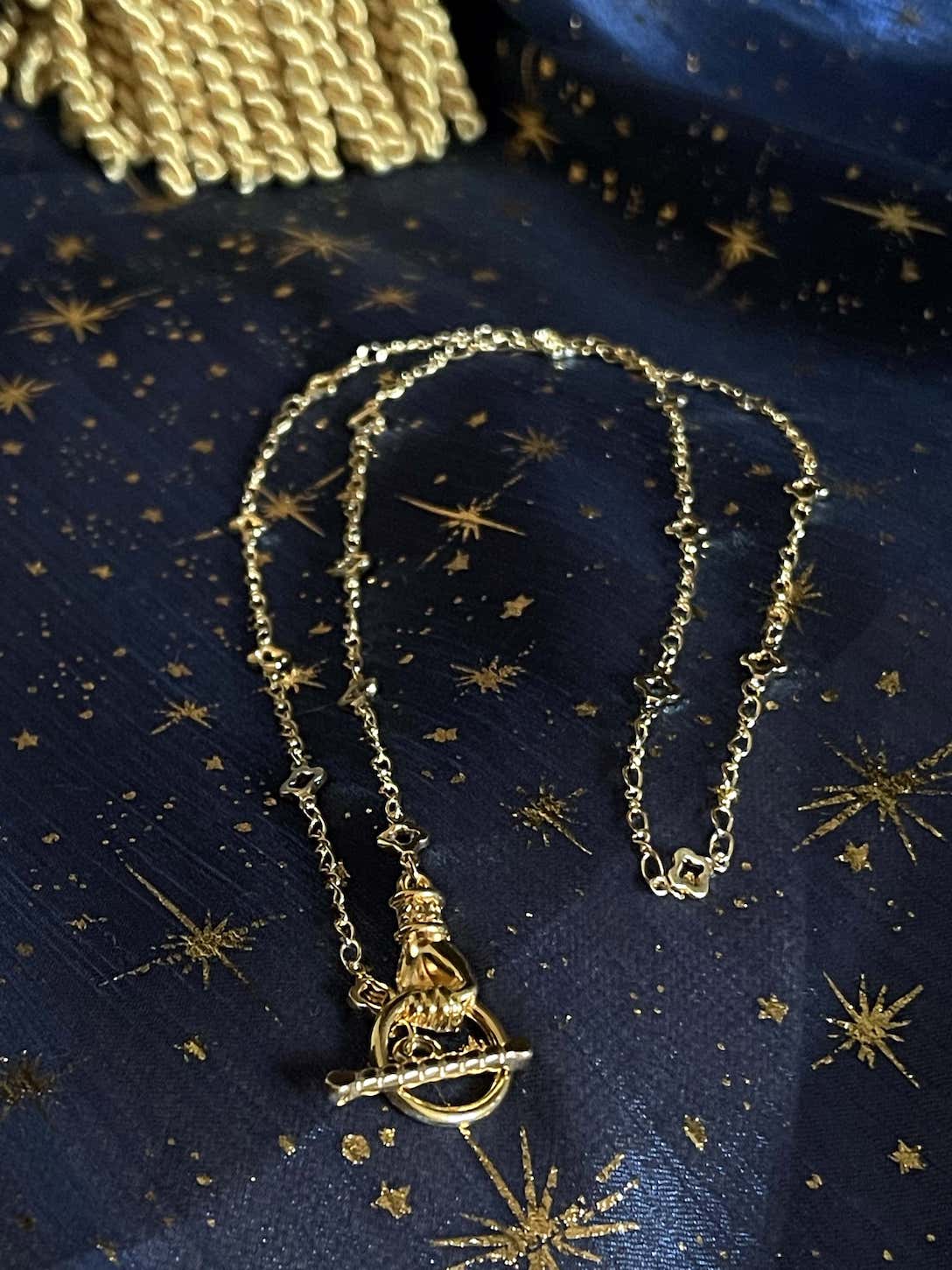A Handmade Medieval Hand Toggle Clasp Necklace in Gold with Quatrefoil Motif Chain.