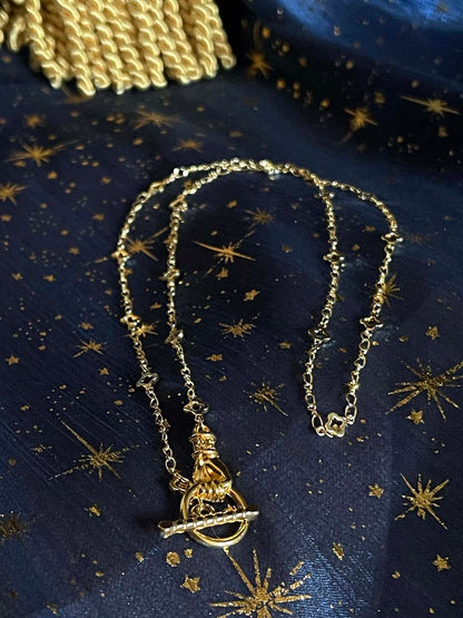 A Handmade Medieval Hand Toggle Clasp Necklace in Gold with Quatrefoil Motif Chain.
