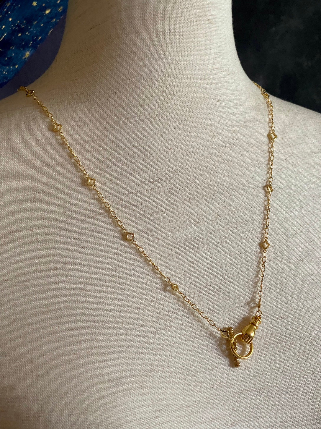 A Handmade Medieval Hand Toggle Clasp Necklace in Gold with Quatrefoil Motif Chain.