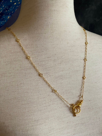 A Handmade Medieval Hand Toggle Clasp Necklace in Gold with Quatrefoil Motif Chain.