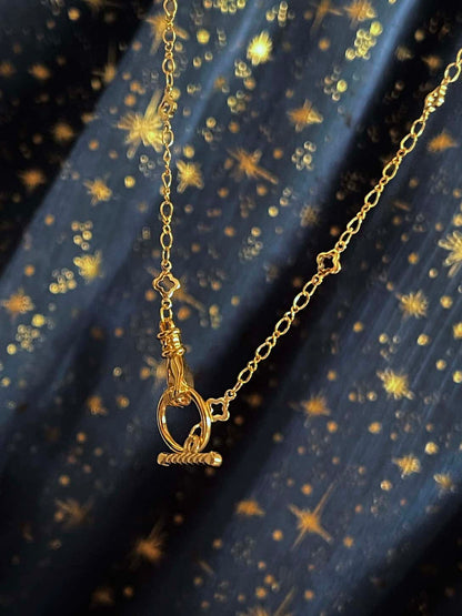 A Handmade Medieval Hand Toggle Clasp Necklace in Gold with Quatrefoil Motif Chain.