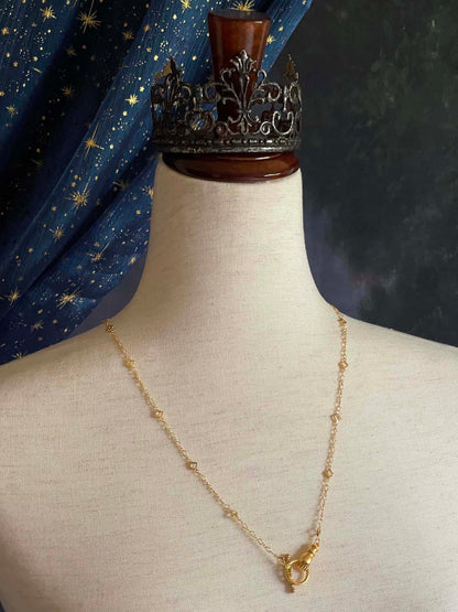 A Handmade Medieval Hand Toggle Clasp Necklace in Gold with Quatrefoil Motif Chain.