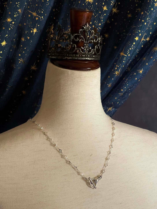 A Handmade Medieval Hand Toggle Clasp Necklace in Silver with Quatrefoil Motif Chain.