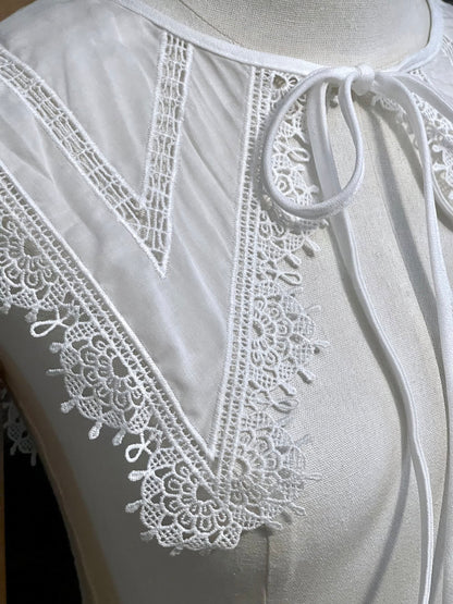 Detail of an Elizabethan era historical fashion inspired white cotton lace trimmed dagger removable collar on a mannequin in front of an art history backdrop.
