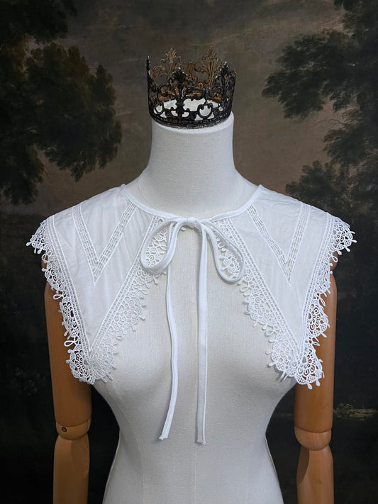 Elizabethan era historical fashion inspired white cotton lace trimmed dagger removable collar on a mannequin in front of an art history backdrop.
