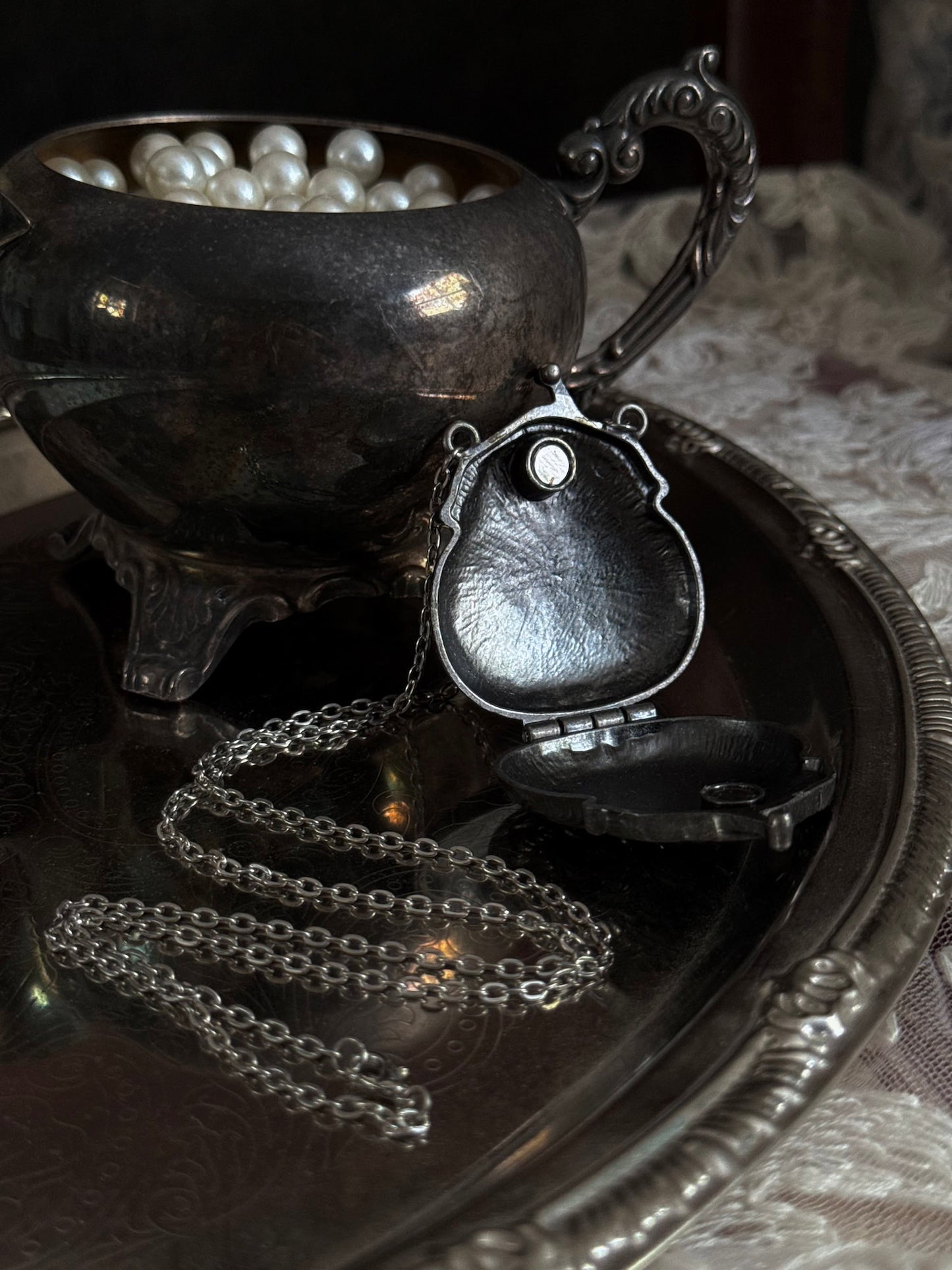 Victorian inspired historical coin purse trinket box pendant necklace with repousse designs in a darkened tarnished finish. Inside view.