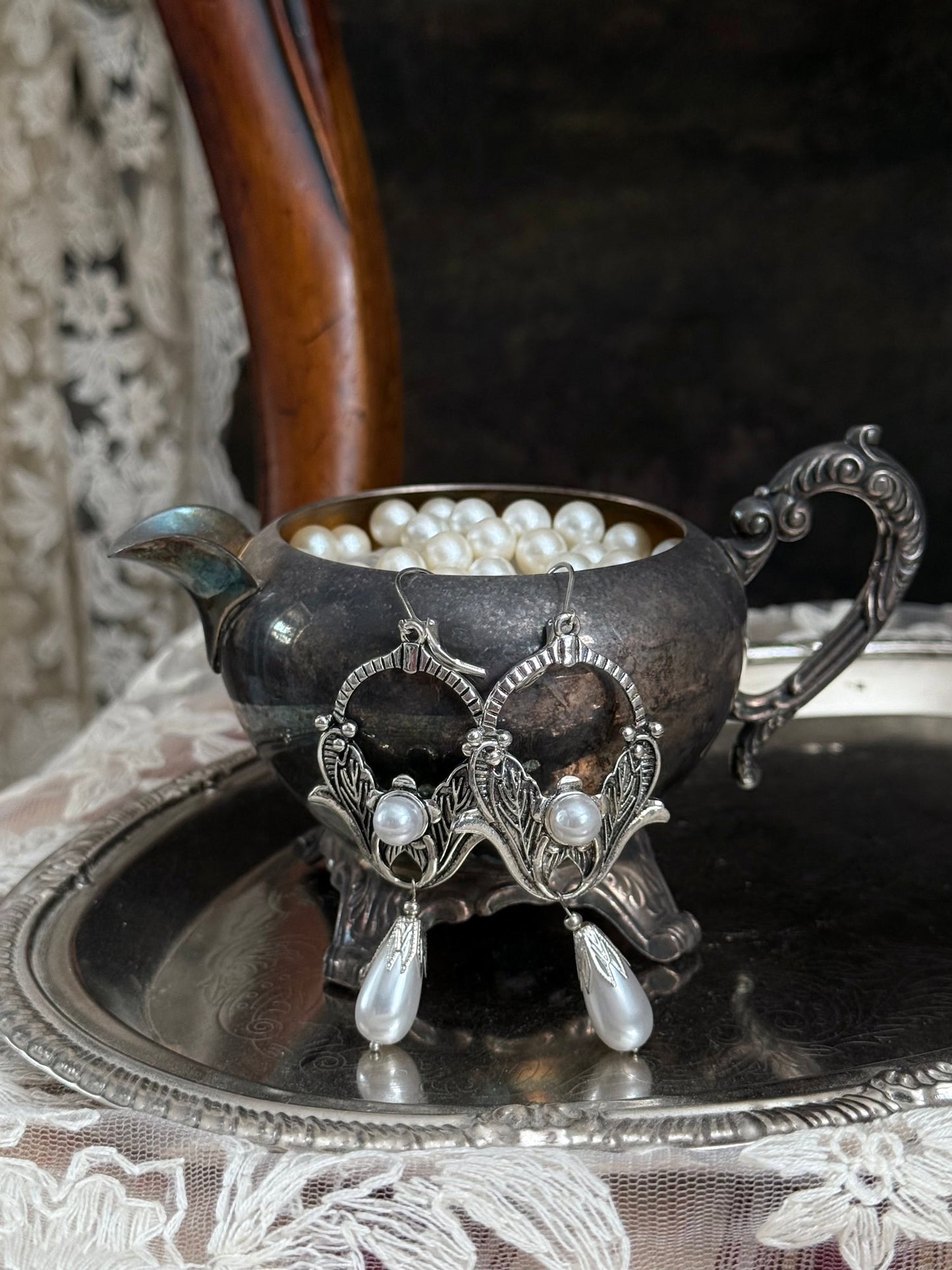 Historically inspired Turn-of-the-Century Art Nouveau Silverwork style  Earrings with Pearl Dangle displayed on an antique silver dish