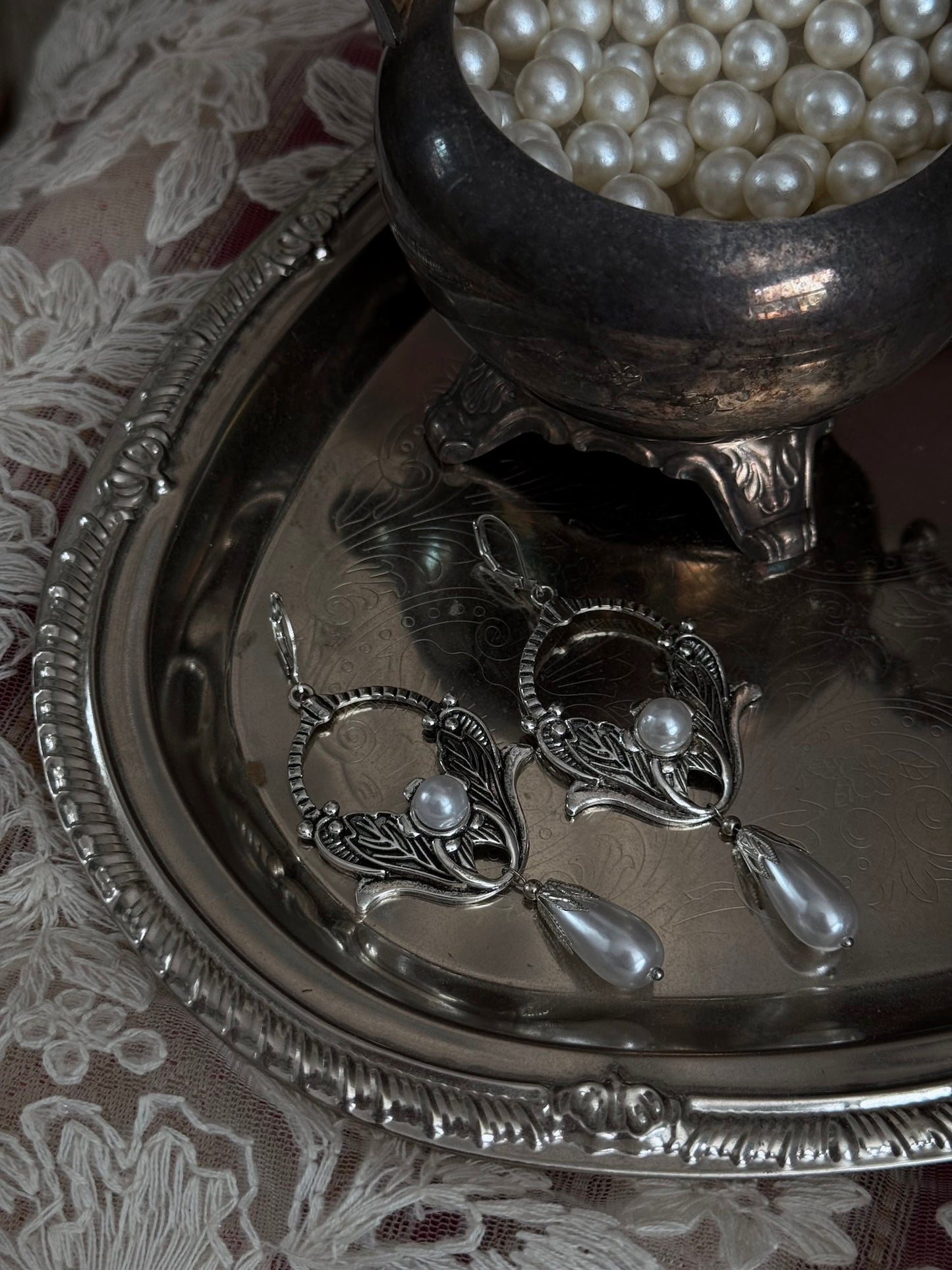Historically inspired Turn-of-the-Century Art Nouveau Silverwork style  Earrings with Pearl Dangle displayed on an antique silver dish