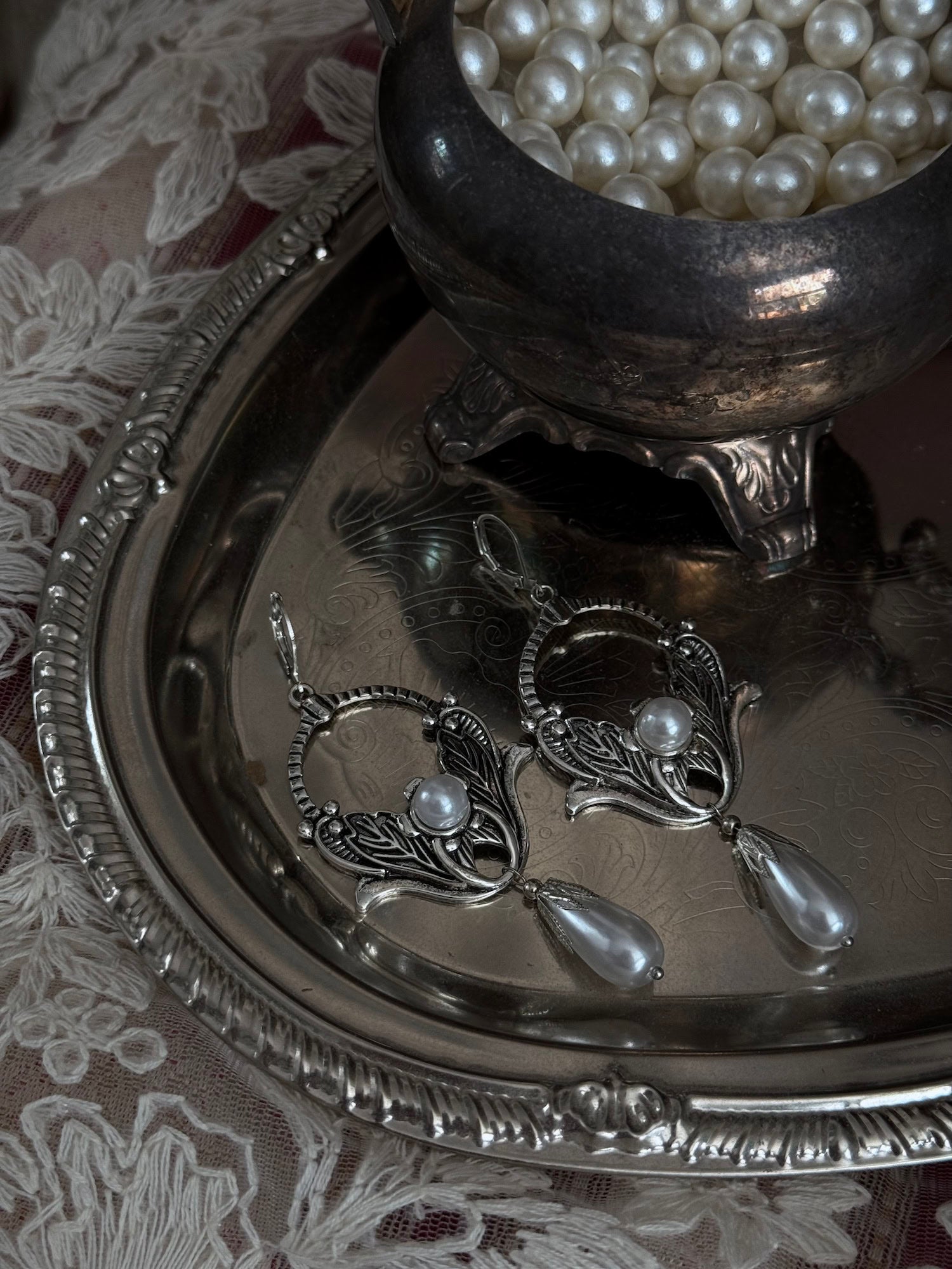 Historically inspired Turn-of-the-Century Art Nouveau Silverwork style  Earrings with Pearl Dangle displayed on an antique silver dish