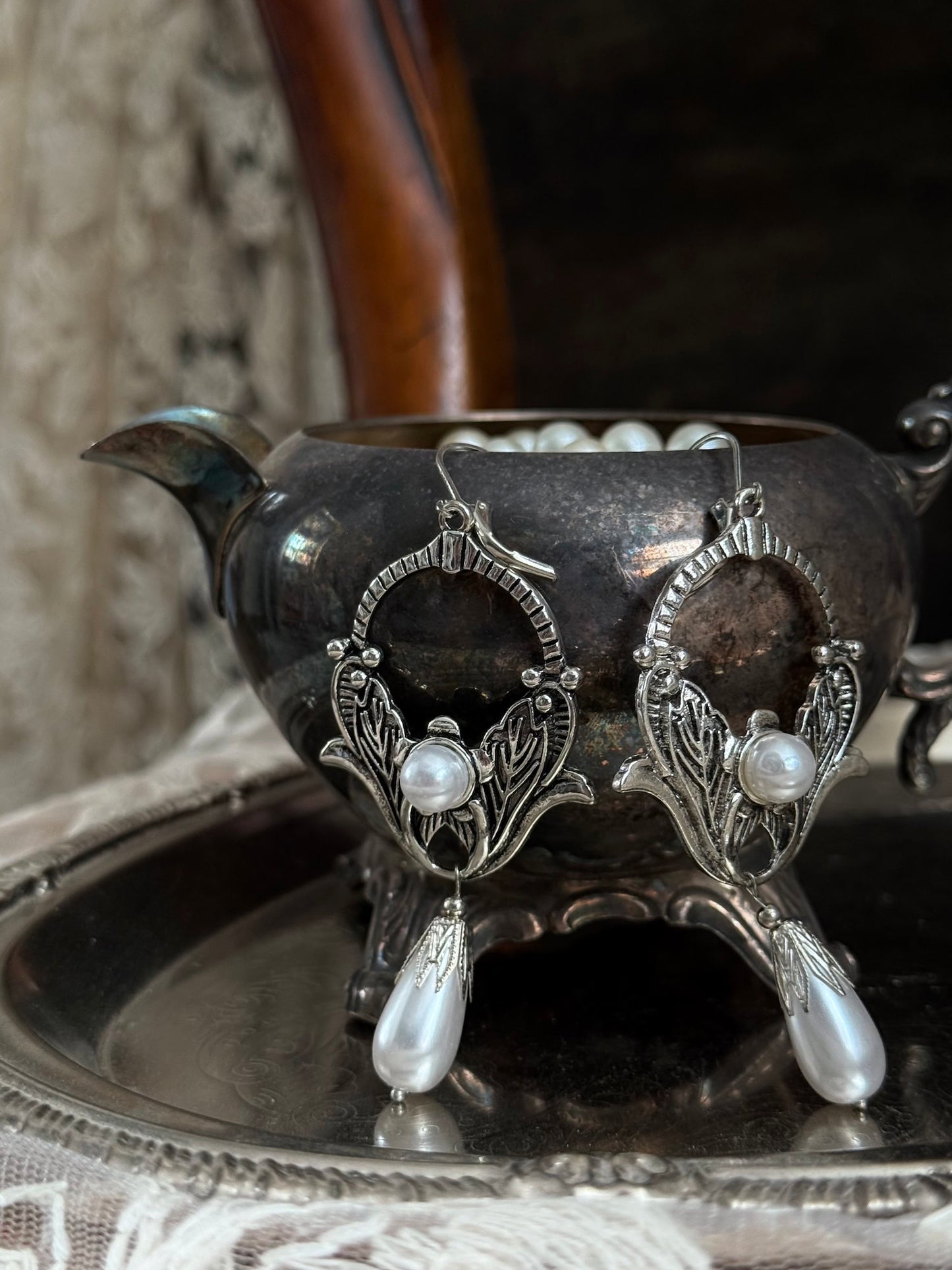 Historically inspired Turn-of-the-Century Art Nouveau Silverwork style  Earrings with Pearl Dangle displayed on an antique silver dish