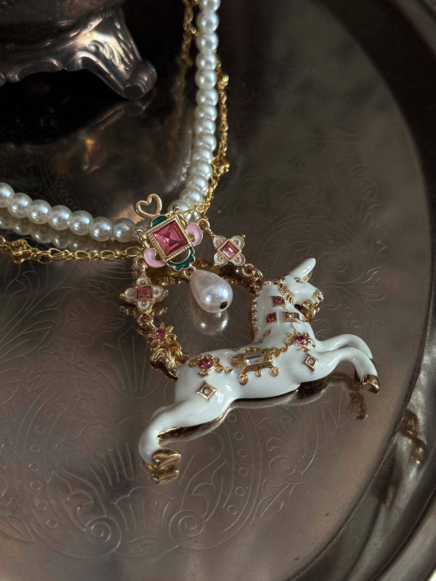 Close up of the jeweled unicorn pendant