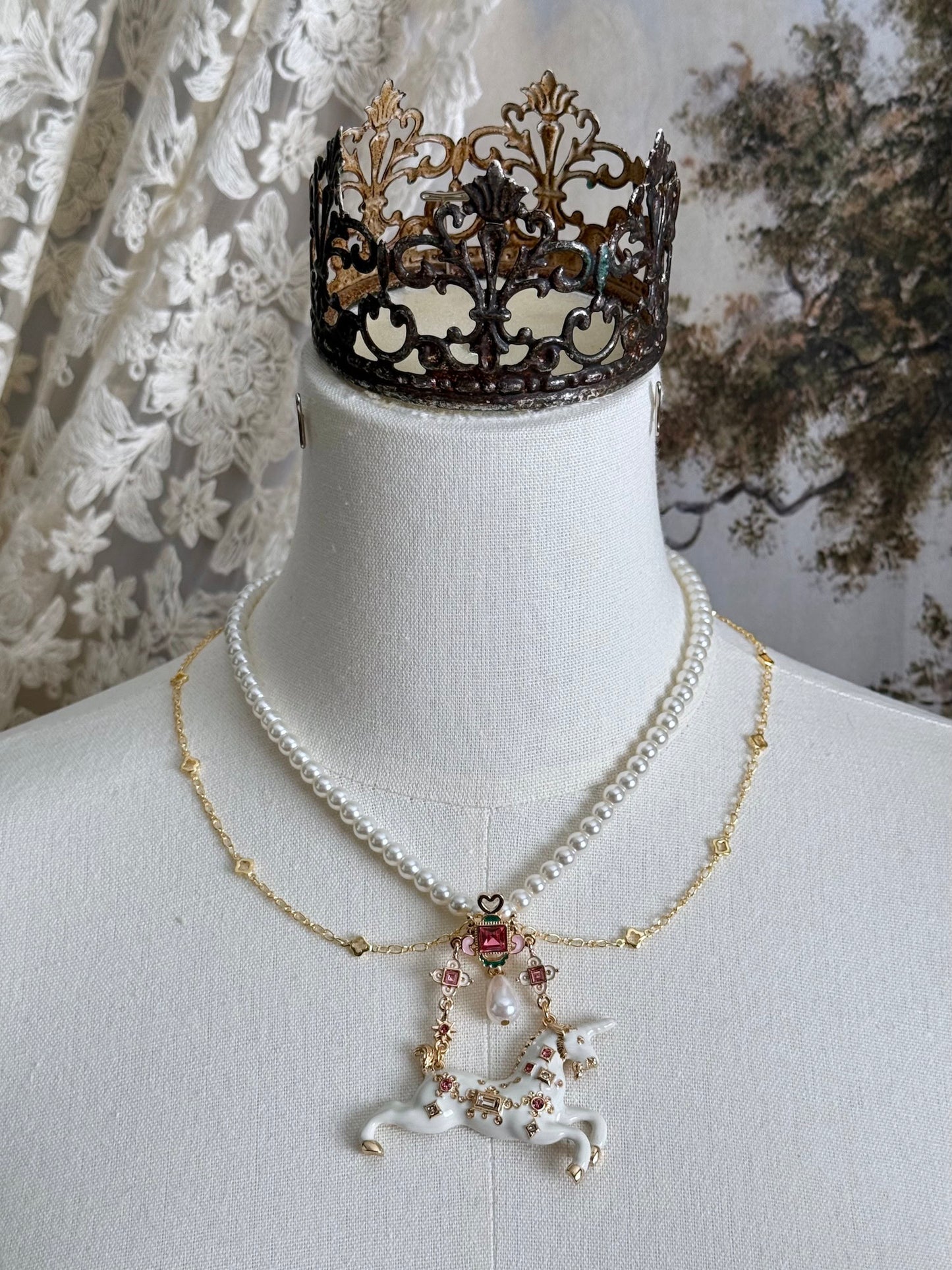 Handmade historical jewelry inspired pearl and chain necklace with a bejeweled medieval unicorn pendant, displayed on a mannequin.
