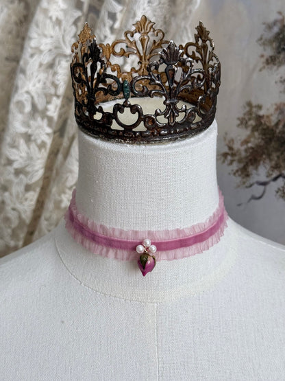 A victorian fashion inspired mauve pink velveteen and chiffon ruffle lace choker necklace with a real rose bud charm and three faux pearl beads pictured on a mannequin