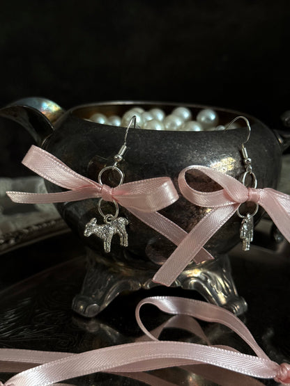 A vintage inspired handmade set of jewelry (earrings and necklace) featuring faux pearl beads, silver lamb charms,  and pastel pink ribbon bows.