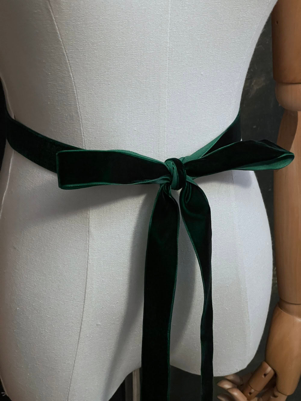 Dark Forest Green medieval style Velvet Belt with gold toned antique belt tips tied in a bow in front of an art history backdrop