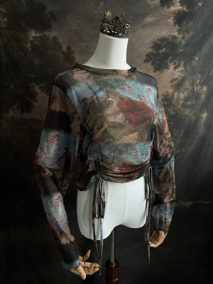 A Historical Renaissance Painting Printed Sheer Mesh Long-Sleeve Ruched Blouse on a mannequin in front of an art history backdrop