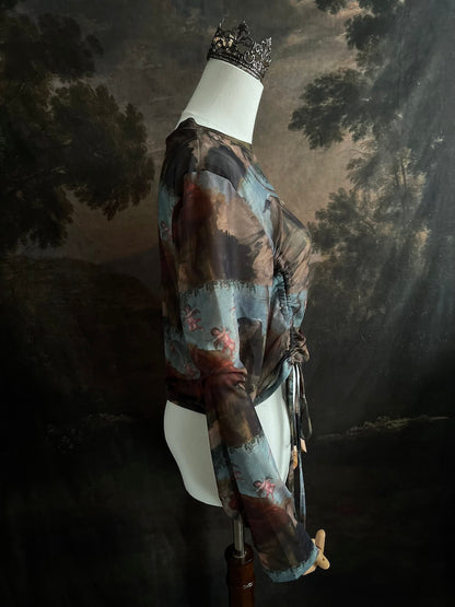 A Historical Renaissance Painting Printed Sheer Mesh Long-Sleeve Ruched Blouse on a mannequin in front of an art history backdrop